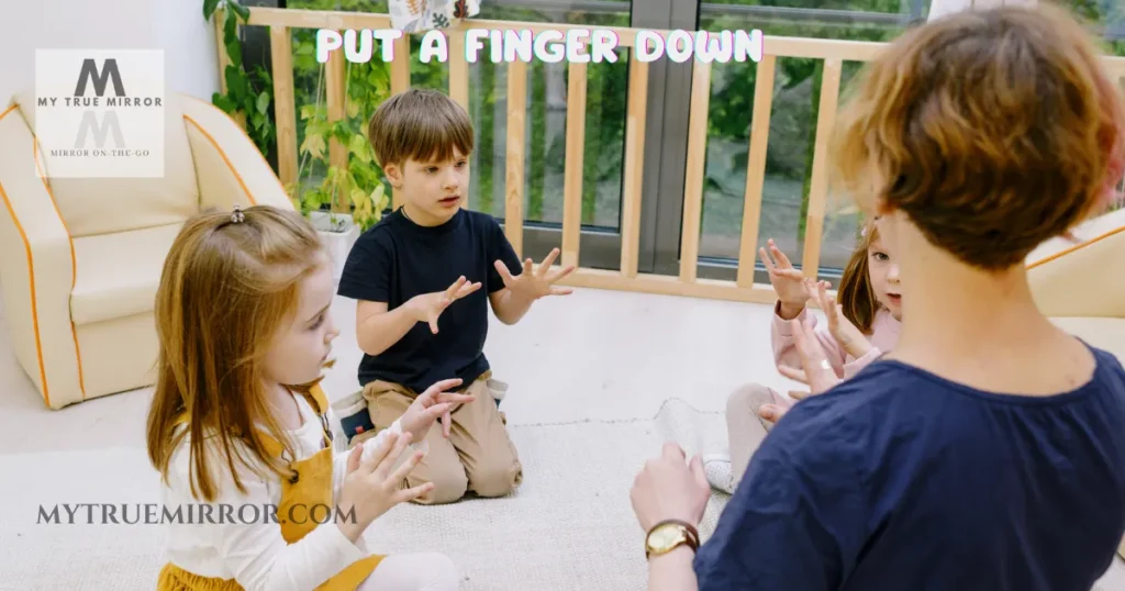 An image showing kids playing "Put a Finger Down if..." game in a group and asking questions